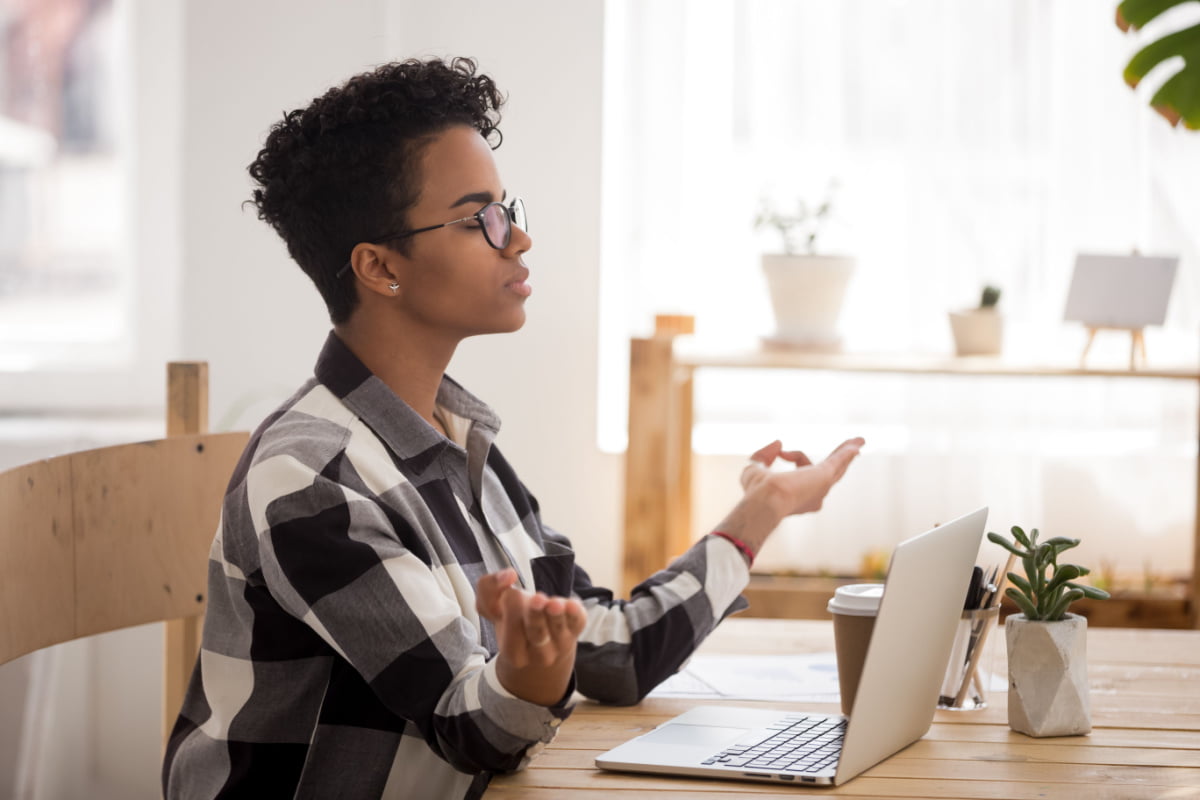 Young Woman At Peace In The Office Small Things You Should be Doing to Increase Positivity in the Workplace