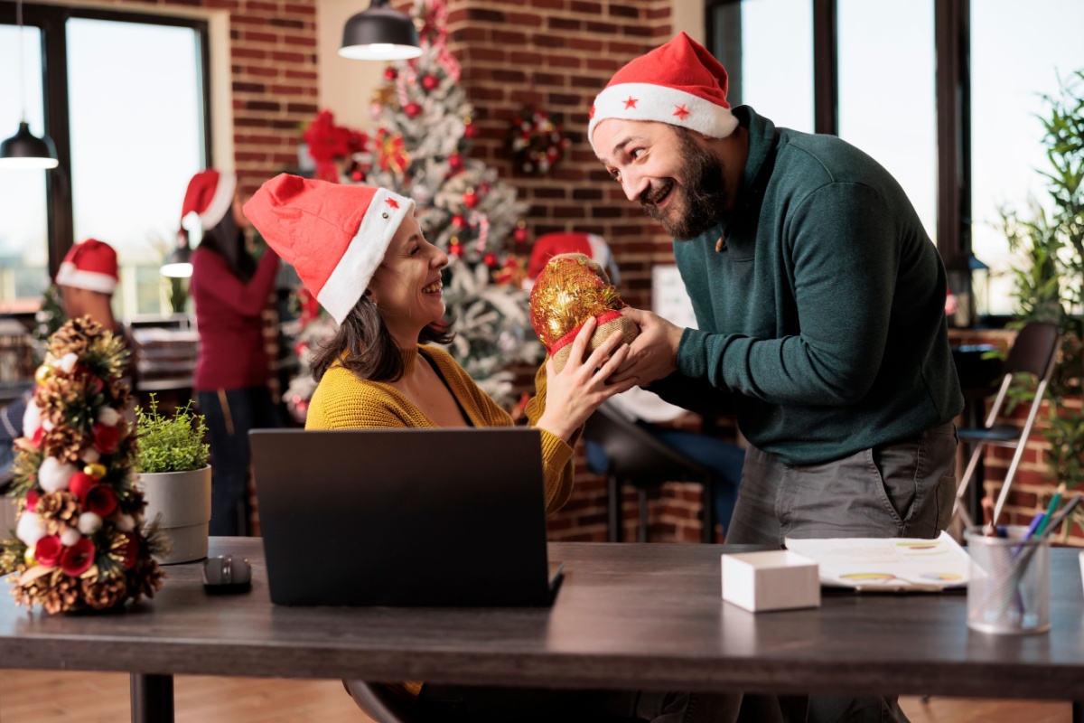 A photo of employees wearing santa hat in a coworking space