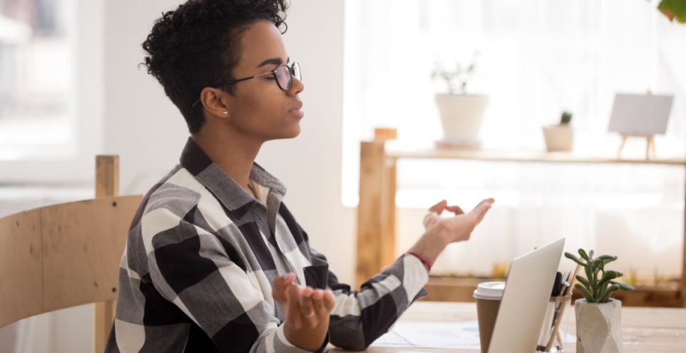 Young Woman At Peace In The Office Small Things You Should be Doing to Increase Positivity in the Workplace