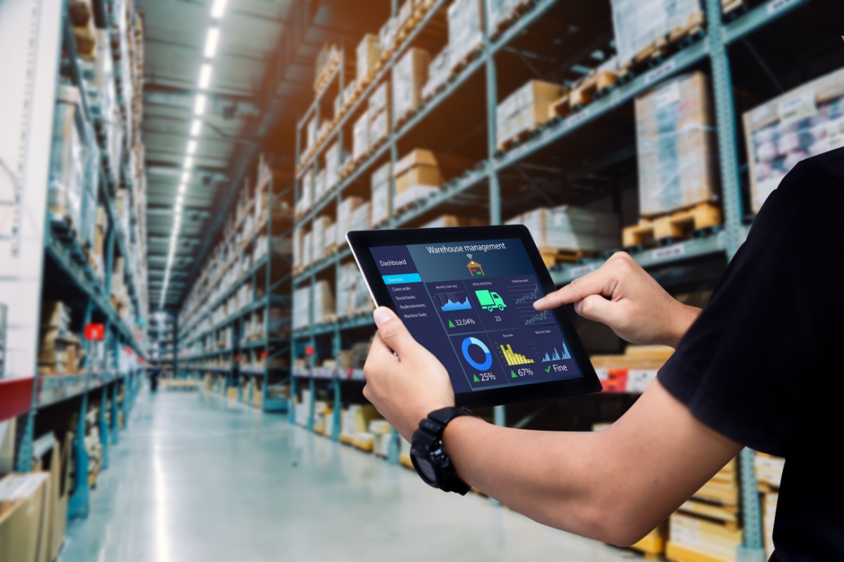 a person using a tablet in a warehouse